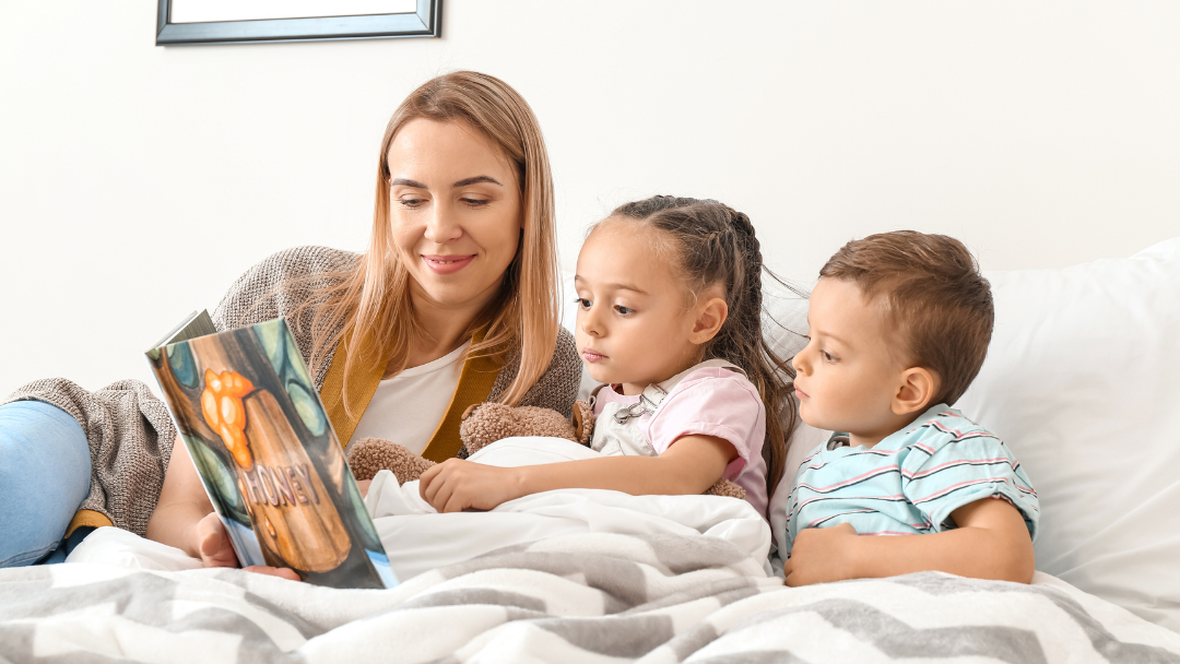 A parent reading a story with two children - Why Working with a Local Catering Company Will Be the Best Business Decision You Make this Holiday Season